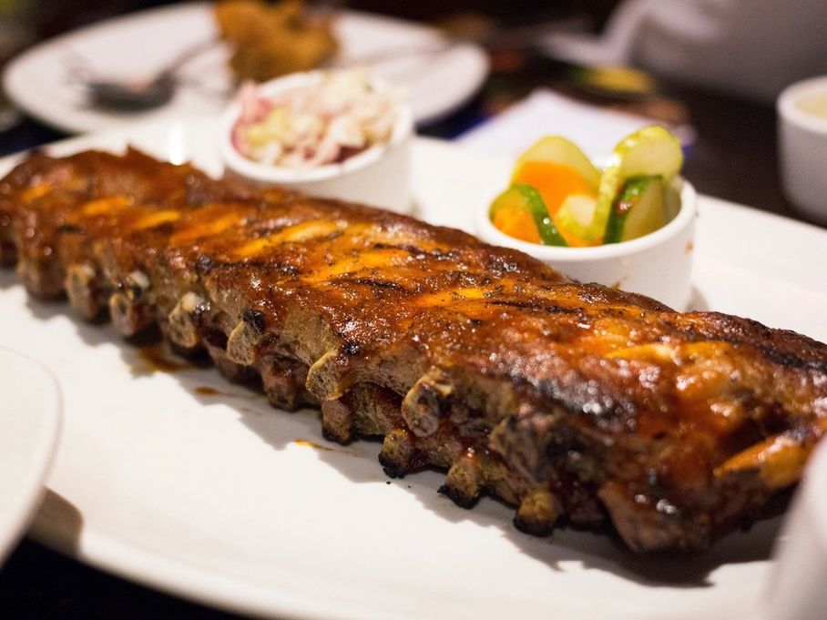 A rack of glazed ribs with sides
