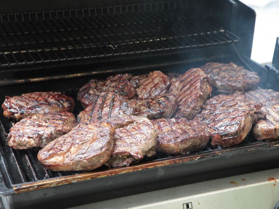 Steaks searing on a grill